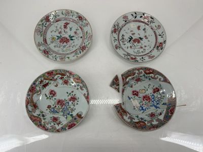 three plates with floral designs on them sitting on a white surface