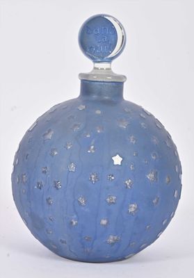 a blue glass bottle with a silver star on the top