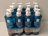 four bottles of hand sanitizer are lined up on a counter