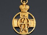 an image of a gold cross with a crown on top of it