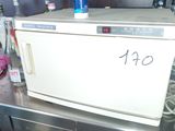a white microwave sitting on top of a metal counter
