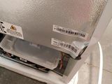 a small refrigerator with a lot of things on it