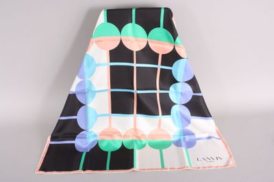a close up of a black and white skirt with blue and green circles on it