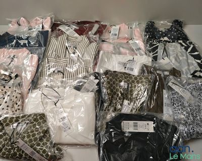 many different types of clothing in bags on a table
