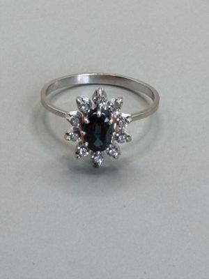 an image of a ring with a sapphire and diamonds