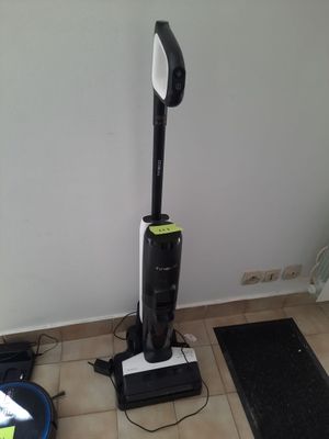 a vacuum that is sitting on the floor next to a rug