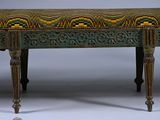 a green bench with a yellow and green design on it