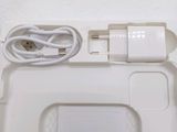 a white box with a charger and a cable attached to it