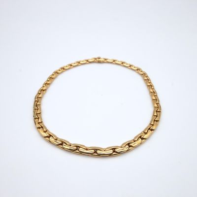a gold chain bracelet on a white background