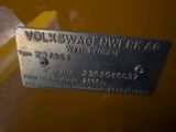 a close up of a metal tag on a yellow vehicle