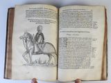 an open book with a drawing of a man on a horse