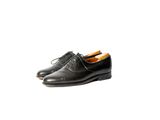 a pair of black shoes on a white background