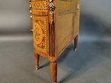a small wooden chest with a marble top on a table