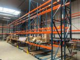 shelves in a warehouse with pallets and boxes on them