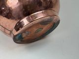 a large copper vase with a blue and green design on it