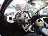 a small car with a steering wheel in a parking lot