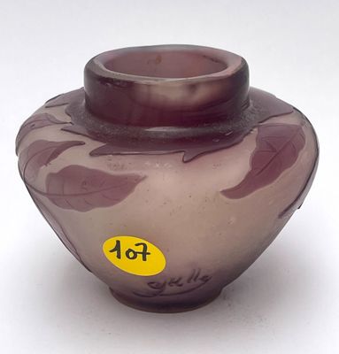 a purple vase with a yellow sticker on it