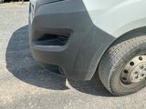 a close up of the front of a car with a flat tire