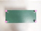 a green board with pink knobs on it