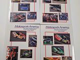 three racing books with pictures of cars on them on a table