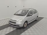 a small silver car parked in a room with a checkered floor