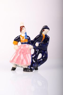 a figurine of a man and a woman riding a horse