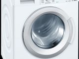 a close up of a white washing machine on a black background