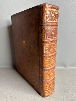 an old book sitting on top of a table next to a wall