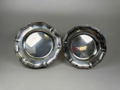 two silverplated dishes on a table with a white background