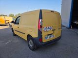 the back end of a yellow van parked in a parking lot
