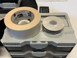 a roll of tape sitting on top of a tape dispenser