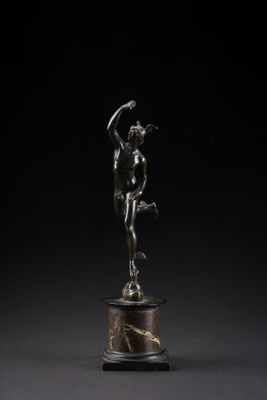 a bronze statue of a woman holding a bird on a pedestal