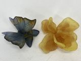 yellow and blue flowers on a white surface next to each other