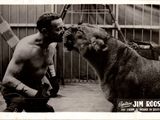 photographie en noir et blanc d'un homme embrassant un chien dans une cage
