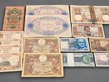 a group of old paper money sitting on top of a table