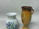 two vases sitting next to each other on a table