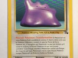 a close up of a pokemon card with a purple object on it