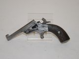 an old gun that is on display on a white surface