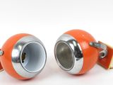 two orange speakers sitting on a white surface