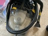 a vacuum that is sitting on the floor next to a bag