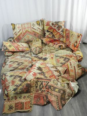 a couch that has a lot of pillows on top of it
