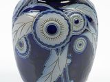a blue and white vase with a flower design on it