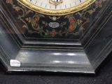 a close up of a clock on display in a glass case