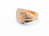 an image of a gold ring on a white surface