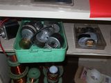 a green container filled with cans under a desk