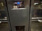 a stainless steel refrigerator with a digital clock on the door