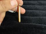 a person holding a small metal object in their hand