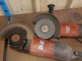 two grinders that are sitting next to each other on the floor