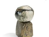 a stone sculpture of a bowl sitting on top of a rock