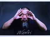 an image of a man with a long beard holding his hands up to his face